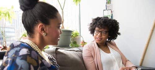 women talking on a couch