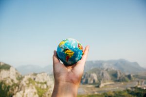 Person holding a globe