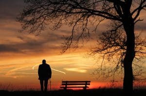 Silhouette of a tree and man against the sunset