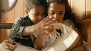 Two children reading a book