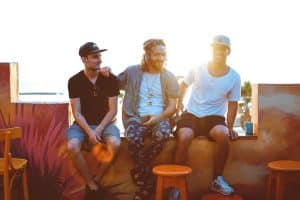 Group of three men chatting and laughing