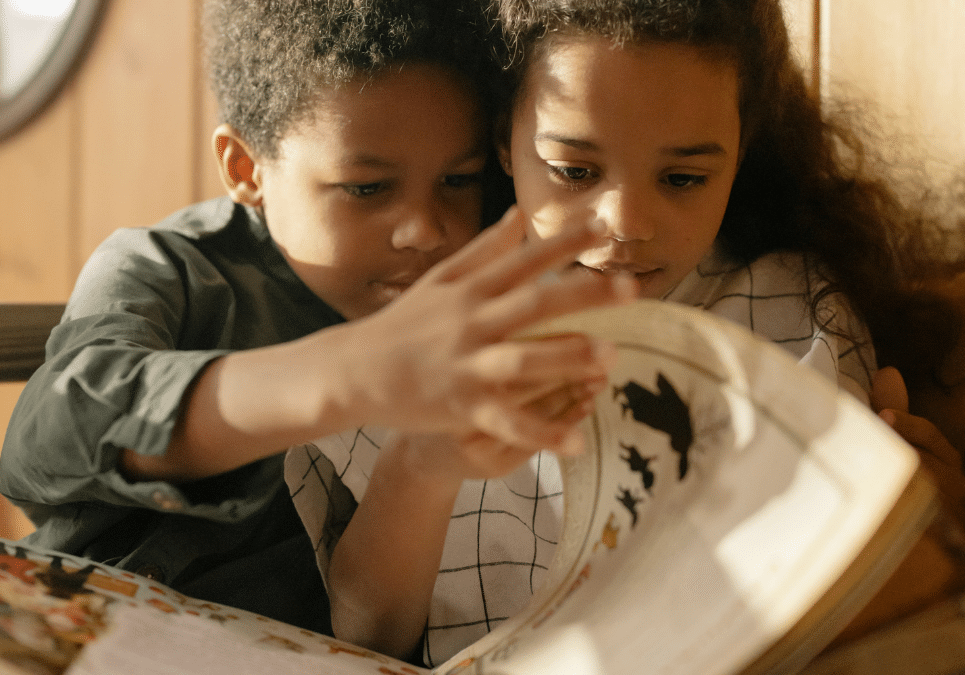 Two children reading a book